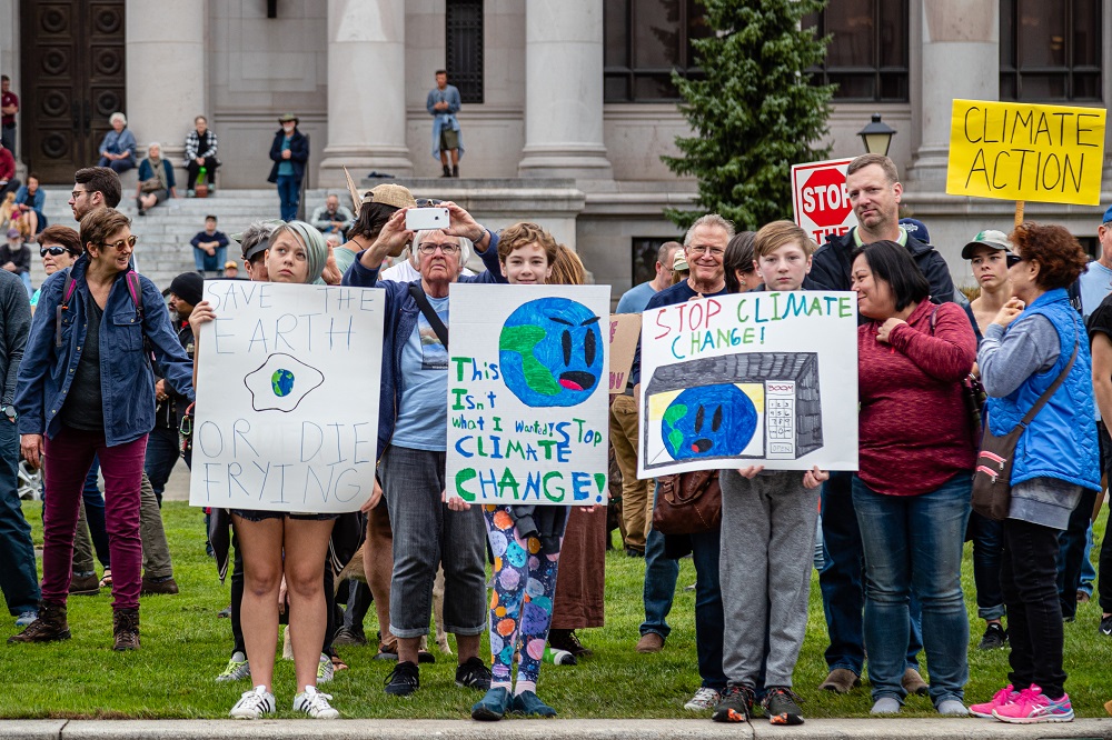 Three holding 3 signs